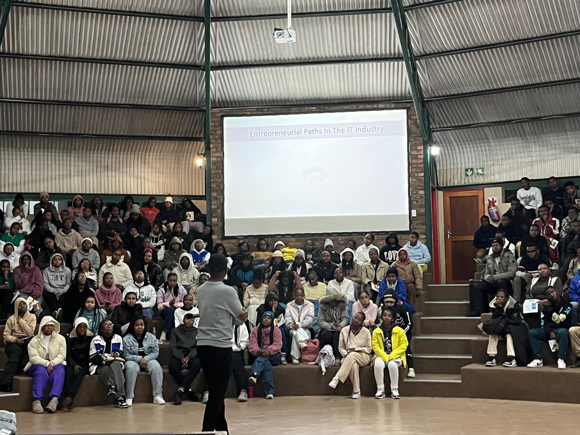 Entrepreneurship presentation in packed auditorium